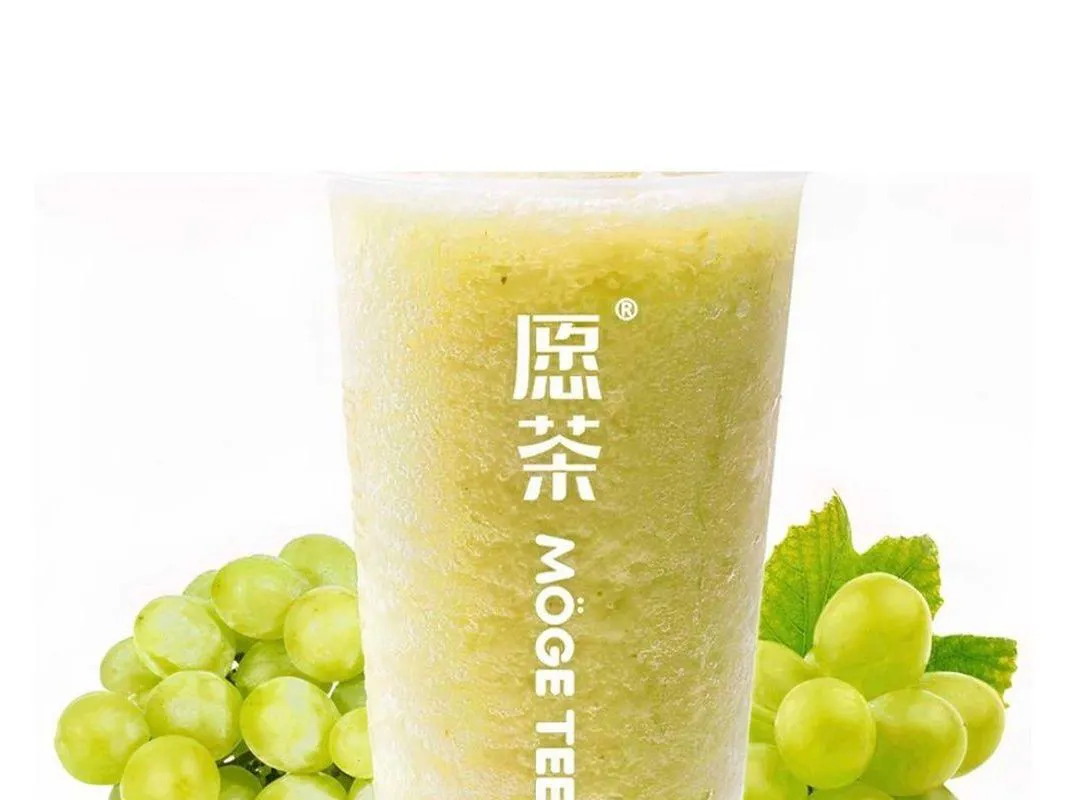 Fresh green grape slush surrounded by whole green grapes at Moge Tee, a Bubble Tea Store in Bellevue
